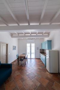 a kitchen and dining room with a table and a refrigerator at Il Rosmarino in Marciana +27 photos