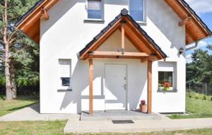 a white house with a white door and windows at 2 Bedroom Gorgeous Home In Niesulice in Niesulice