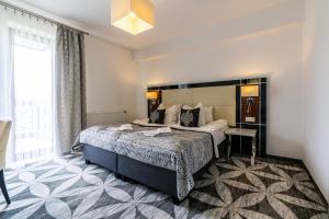 Postel nebo postele na pokoji v ubytování ApartHotel Tatry de Luxe FizjoMedical & Spa