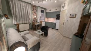 a living room with a couch and a kitchen at Au Cygne in Hoerdt