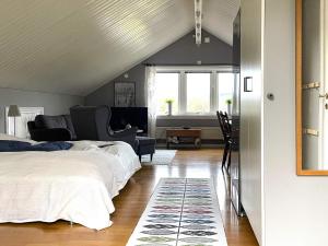 a bedroom with two beds and a living room at 4 star holiday home in Romelanda in Romelanda