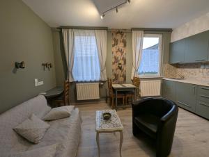 a living room with a couch and a table at Au Cygne in Hoerdt