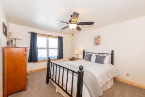a bedroom with a bed and a ceiling fan at Peace and Quiet in the mountains in Tabernash