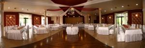 a banquet hall with white tables and chairs at Zajazd Beskidy in Żywiec