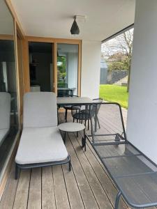 a patio with a table and chairs on a deck at Klokočná in Klokočná