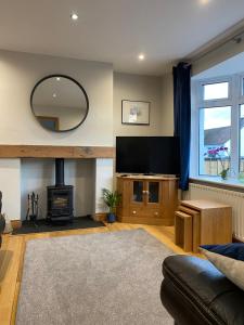 a living room with a flat screen tv and a fireplace at Bushmills holiday home in Bushmills