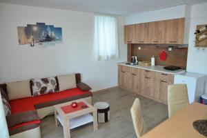 a living room with a couch and a kitchen at Apartmani Moskva in Kopaonik +30 photos