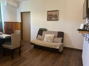 a living room with a couch and a table at Guesthouse D&D in Ličko Petrovo Selo