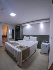 a bedroom with a large bed in a room at Pousada Recanto Dourado in Bonito