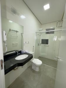 a bathroom with a toilet and a sink and a shower at Pousada Recanto Dourado in Bonito +20 photos