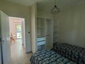 a bedroom with a bed and a closet with shelves at Casa Ines in Yerba Buena