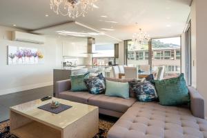 a living room with a couch and a table at Mirage Luxury by NIVAR in Cape Town