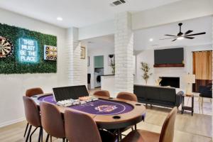 a dining room with a table and chairs and a couch at City Gem 4BR with POOL Sleeps 8 in Plano