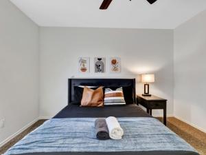 a bedroom with a bed with two towels on it at City Gem 4BR with POOL Sleeps 8 in Plano +31 photos
