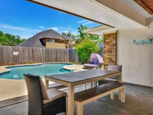 a patio with a table and chairs next to a swimming pool at City Gem 4BR with POOL Sleeps 8 in Plano