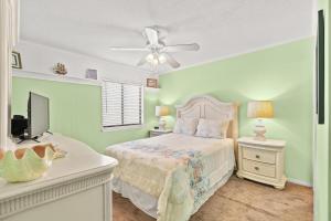 a bedroom with a bed and a flat screen tv at Sea Cabin 147 - 2nd Row - Cherry Grove Section in Myrtle Beach +11 photos