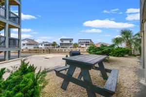 a picnic table in a park with houses in the background at Sea Cabin 147 - 2nd Row - Cherry Grove Section in Myrtle Beach
