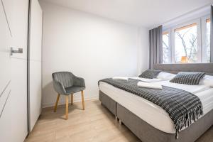 Posteľ alebo postele v izbe v ubytovaní Apartament26
