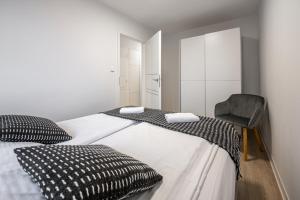 Posteľ alebo postele v izbe v ubytovaní Apartament26