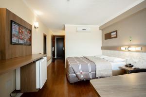 Postel nebo postele na pokoji v ubytování Hotel 10 Ponta Grossa