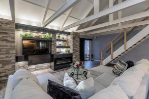 a living room with white furniture and a fireplace at 573 Queen's Grant in Coffeyville