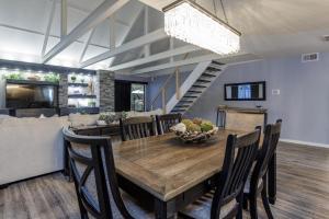 a dining room with a wooden table and chairs at 573 Queen's Grant in Coffeyville