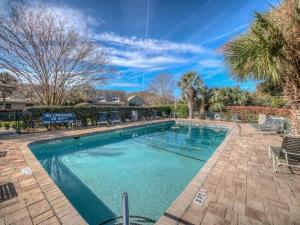 a swimming pool with blue water in a home at 573 Queen's Grant in Coffeyville
