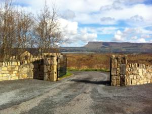 an entrance to a stone wall on a road at Down Yonder Boutique B&B in Sligo