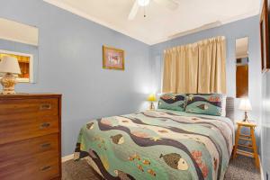 a bedroom with a bed and a dresser in it at Savannah Beach & Racquet Club 211B in Tybee Island +41 photos