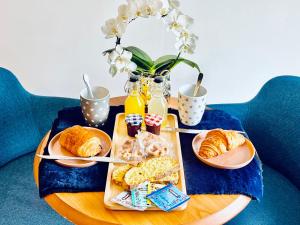 a table with a tray of pastries on a table at Les 2 caps studio beach in Calais