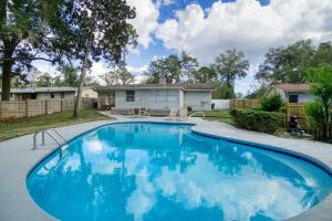 a swimming pool in front of a house at Summer Spot! Luxe Poolside Escape in Julington Creek in Jacksonville