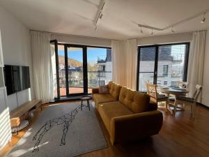 a living room with a couch and a table at Happy Moments - widokowy apartament in Jelenia Góra