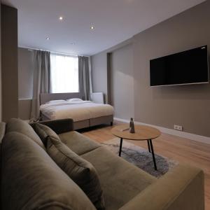 a living room with a couch and a bed at Living Room Apartments in Rotterdam