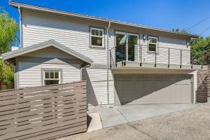 a house with a fence and a garage at Chic 1BR DADU in Queen Anne in Seattle