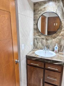 a bathroom with a sink and a mirror at Amplia casa cerca malecón in La Paz +34 photos