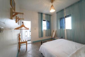 a bedroom with a bed and two chairs and a window at Surf sets house in Agadir +27 photos