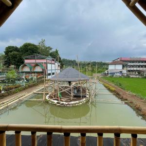 a small boat with a canopy in a canal at Homestay Syariah VIP Kadudampit Sukabumi in Citamiang