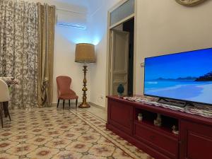a living room with a large flat screen tv at Al Baglio Apartments in Partinico