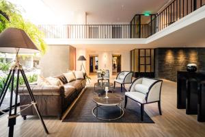 a living room with a couch and chairs at Hotel Once Bangkok in Bangkok +63 photos