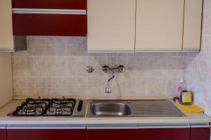 a kitchen counter with a sink and a stove at Casa Daniele in Savigno