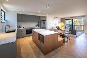 a kitchen with a table and a dining room at Bermagui Beach Hotel in Bermagui