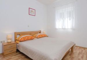 Postel nebo postele na pokoji v ubytování Apartments Ljuba