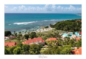 an aerial view of a resort and the ocean at TI KAZ DOUDOU - village de vacances bord de mer in Sainte-Anne
