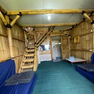 a room with two beds and a ladder and a table at Homestay Syariah Tipe A Kadudampit Sukabumi in Citamiang