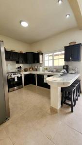 a large kitchen with a table and a refrigerator at Casa Jumay Mallorca in Achiotes Jumay +43 photos