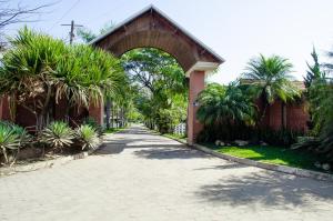 a brick building with an archway next to a street at Pousada Bela Vista in Sengés