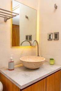 a bathroom with a sink with a large bowl at Family Condo with 3 Bedrooms Pool & Hot tub in Acapulco