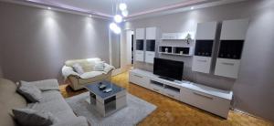 a living room with a couch and a television at Centar ljubavi in Kruševac