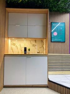 a building with white cabinets and a sign on it at L'appart'hôtel 23ème avenue - Spa privatif - Love room - Appartements à thèmes in Lamalou-les-Bains