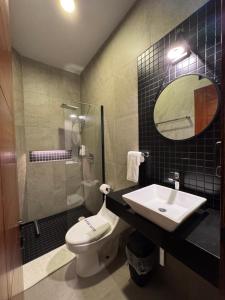a bathroom with a sink and a toilet and a mirror at Aurora Hotel Boutique in Santa Cruz Huatulco +17 photos